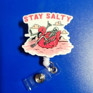 Stay Salty Skeleton on a Flamingo pool float Retractable Badge Reel